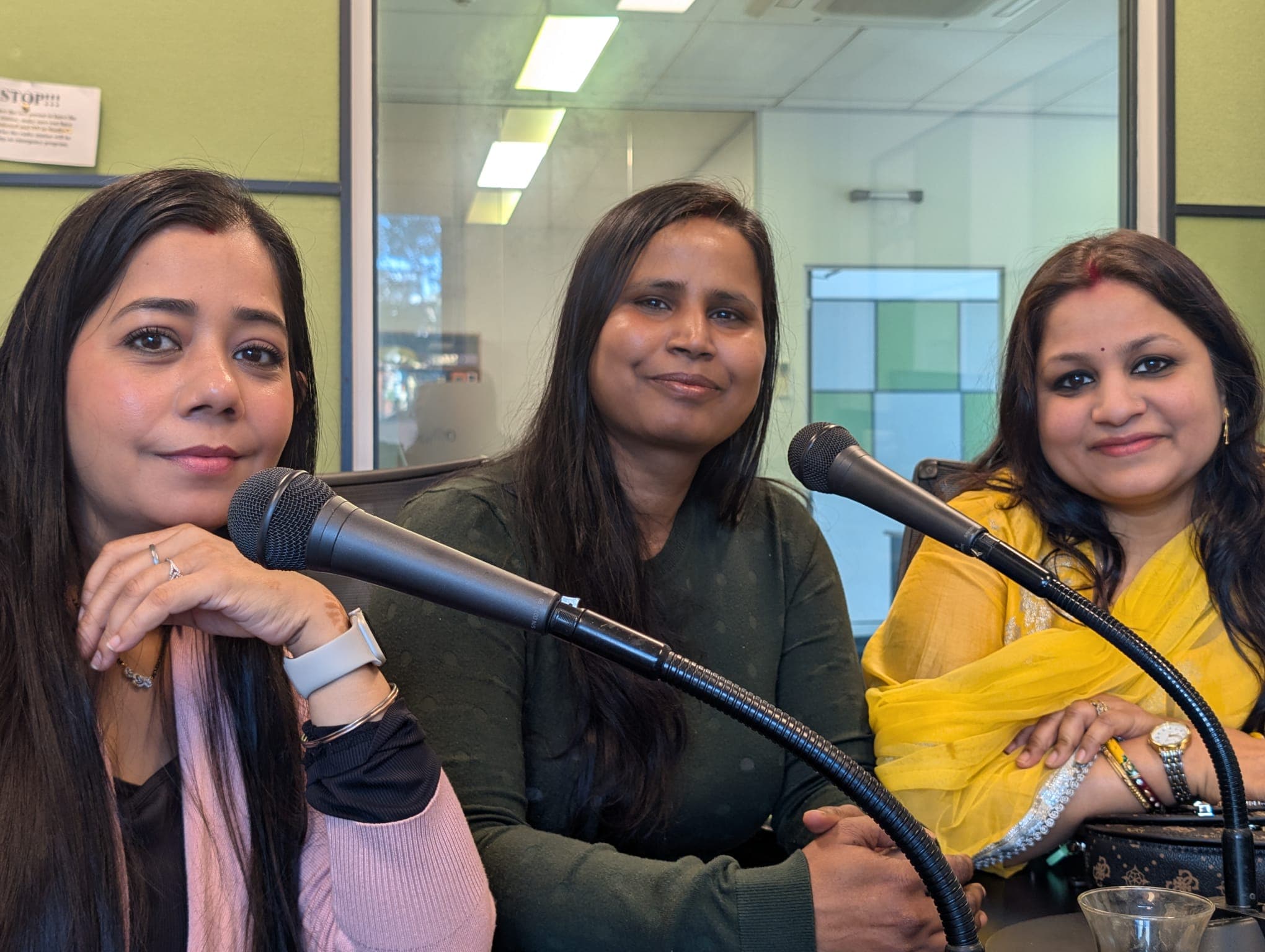 Three Mithila Gunj participants seated together at studio microphones